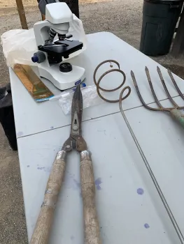 Tools for mixing, measuring temperature, and monitoring microorganisms shown during a composting workshop. Bonita Malone