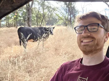 Conor headshot with cow in background