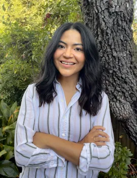 A headshot of Jasmin Ramirez-Strain smiling outside