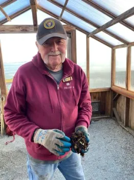 Vermiculturist Dick Miner shows a handful of his award-winning compost