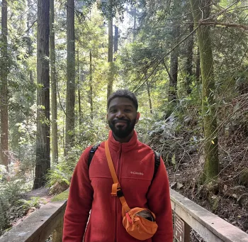 Zimmi Ndlovu standing in a forest