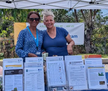 Two Master Gardeners are pictured here at an information booth of gardening information.