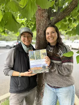 Maddy Mikles and Calli-Jane West with the Backyard Stewardship Guide. Lauren de Terra