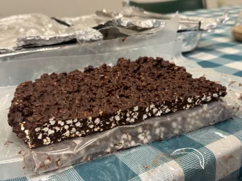 A long bar of chocolate containing white bits of popped sorghum