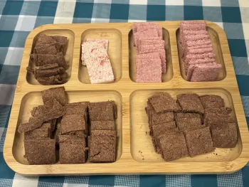 Brown, white and pink sorghum crackers on a tray