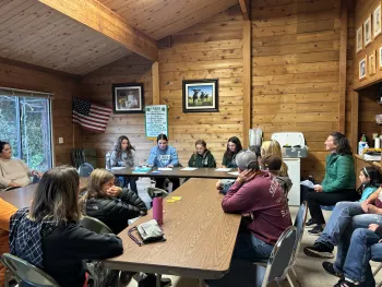 A group of people in a room at a 4-H club meeting about to go over business for the day.