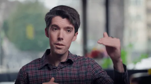 Headshot of Daniel speaking and gesturing with his hands