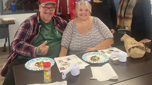 Burkes smile at a table during an EFNEP class