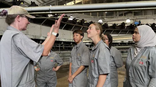 Deniece Williams, left, talks to vet med interns about rotary milking parlors