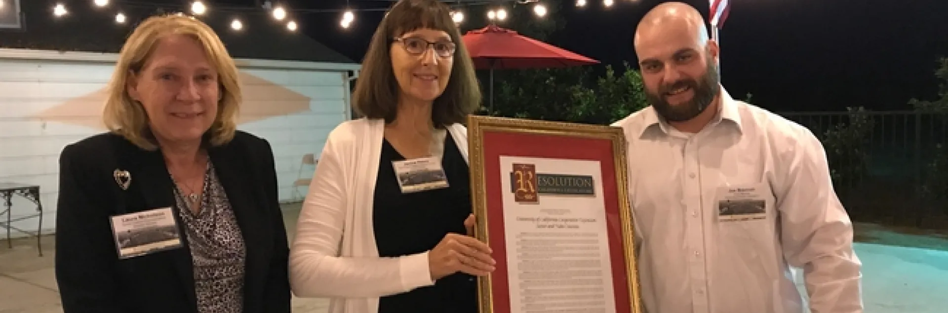 In recognition of UCCE Sutter-Yuba's centennial, Janine Hasey, center, was presented a Senate/Assembly Resolution by Laura Nicholson, senior district representative for state Senator Jim Nielsen, and Joe Brennan, who represented Assemblymember James Gallagher.