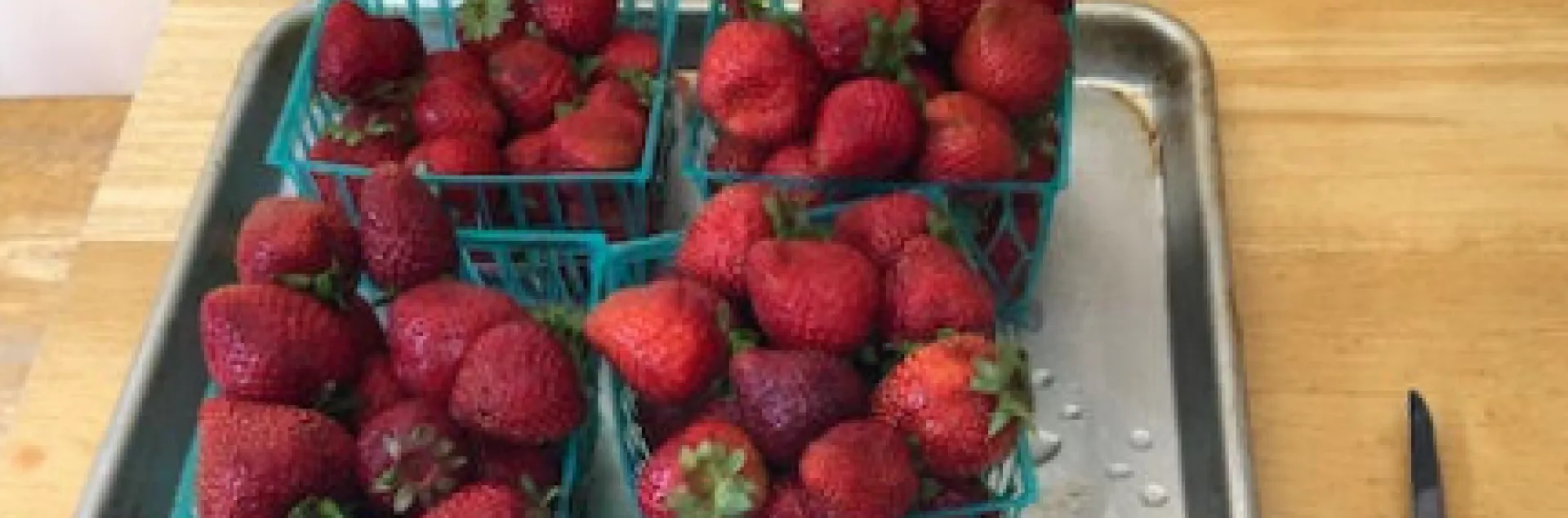 Washed and cut strawberries ready to make jam