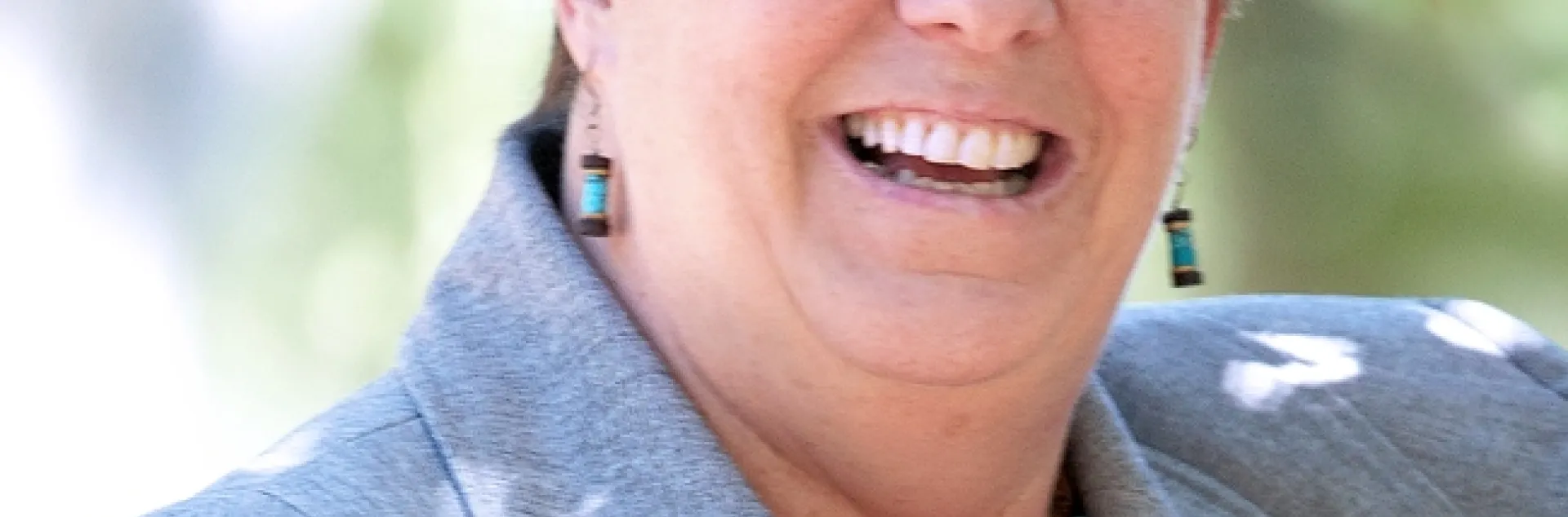 Headshot of Glenda Humiston wearing gray blazer over a red top.