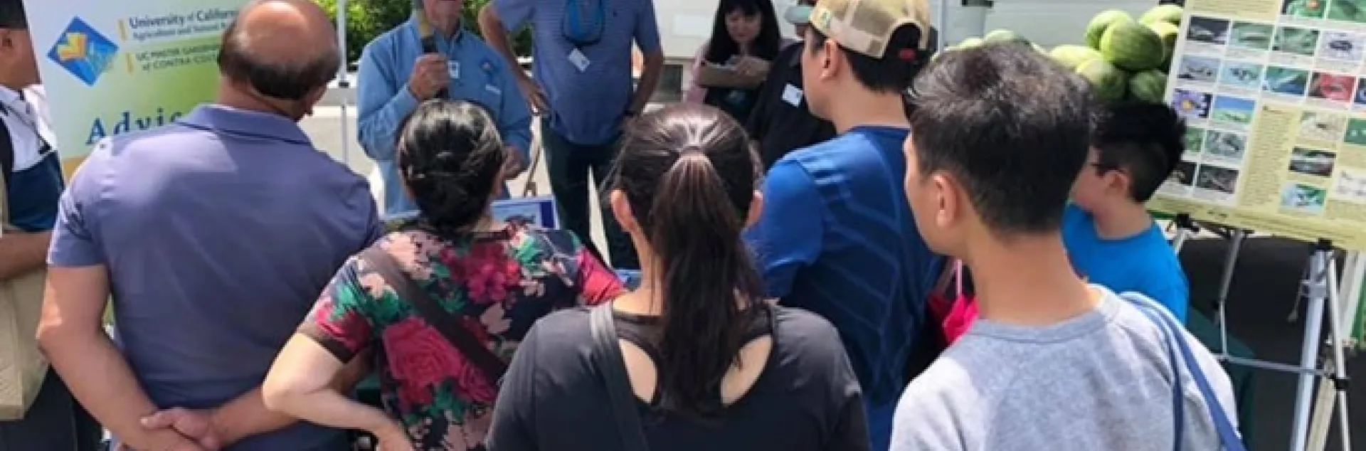 Co-Leads Greg Doyle and Terri Takusagawa look on as CoCoMG Bob Archer talks with the public at the San Ramon Farmers Market. Photo by Harv Singh.