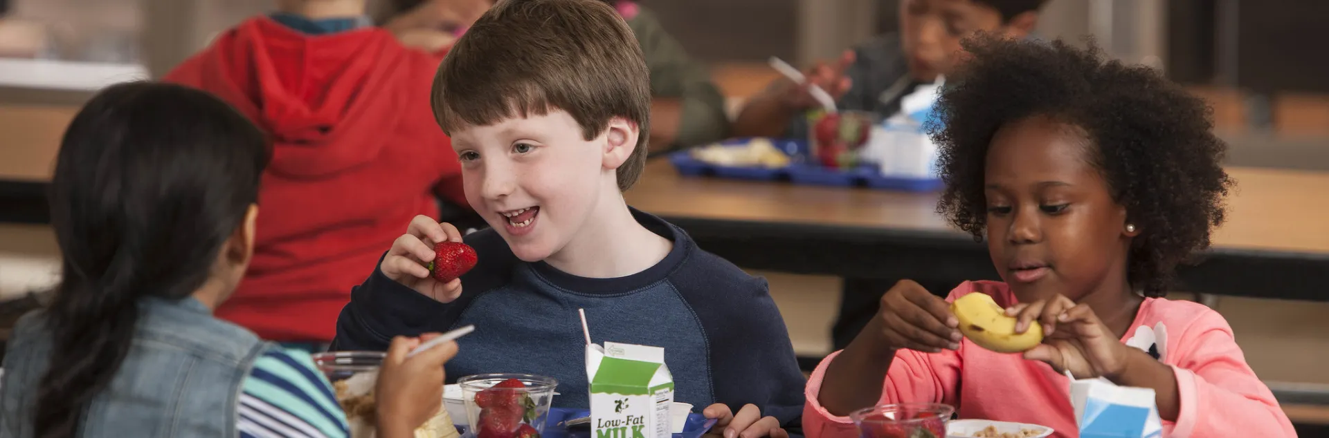 Children in cafeteria eating school meals. Photo credit: USDA.