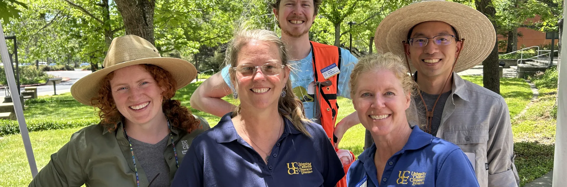 Fire and forestry team members smile amid trees