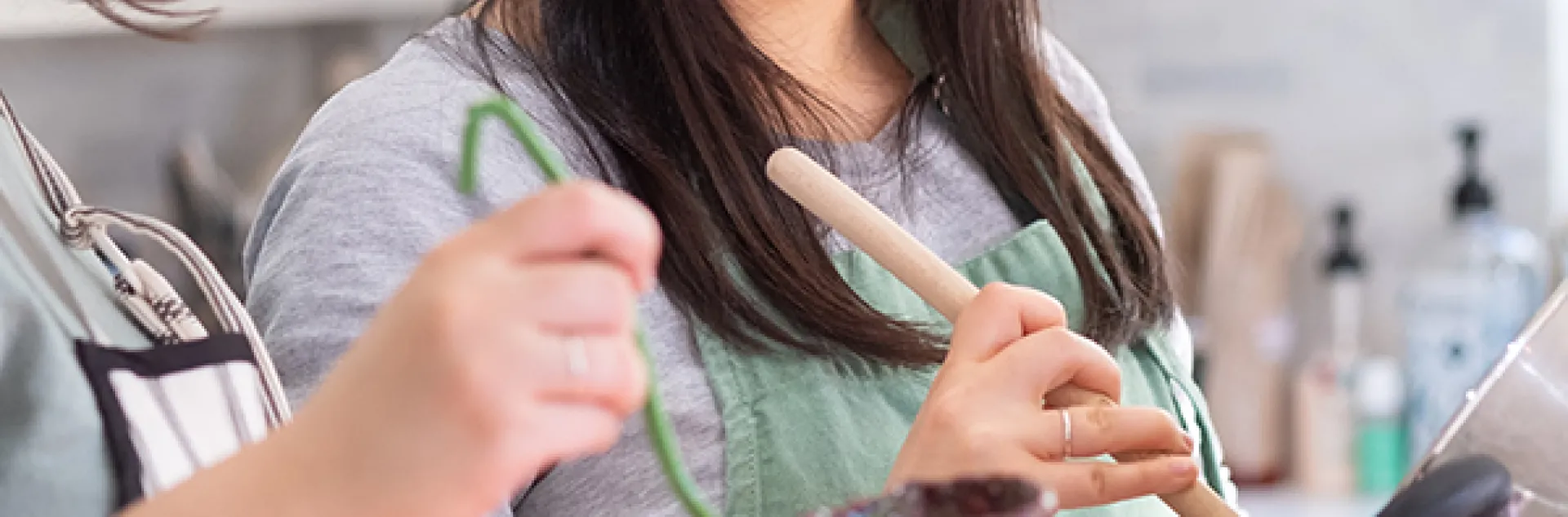 Two women water bath canning jam
