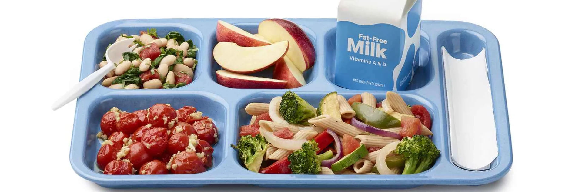A tray of school food including fresh fruits, vegetables, milk and an entree.