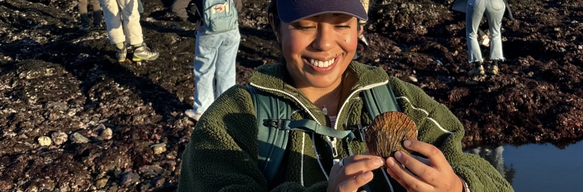 Daisy Prado holds a shell as she explores Duxbury Reef as part of a UC California Naturalist course excursion