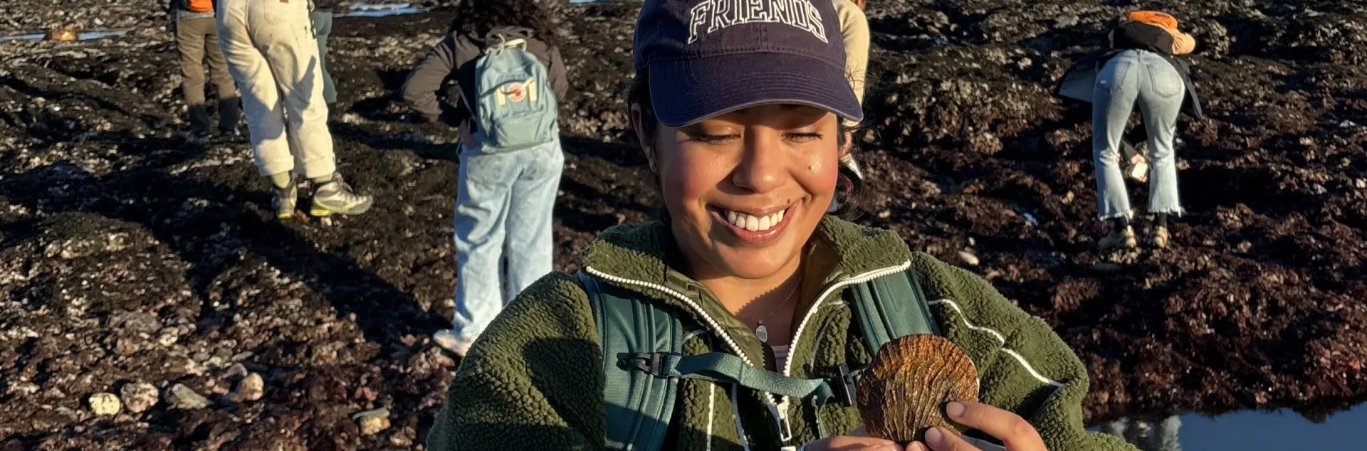 Daisy Prado holds a shell as she explores Duxbury Reef as part of a UC California Naturalist course excursion