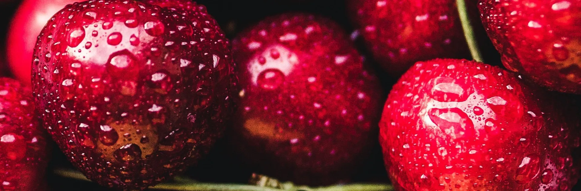 a close up of washed fresh red cherries