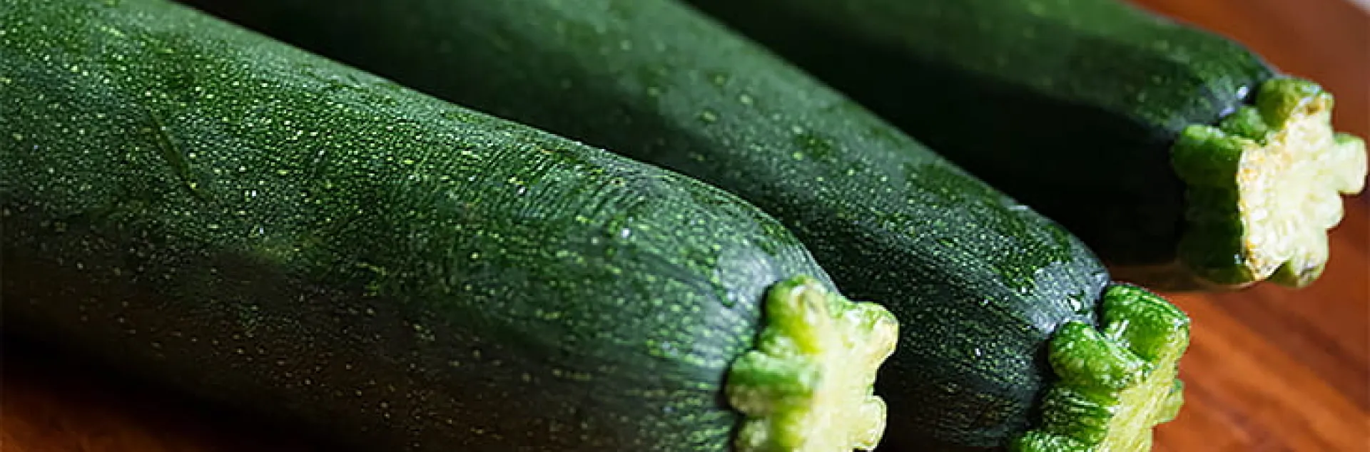 3 zucchini on a wooden board
