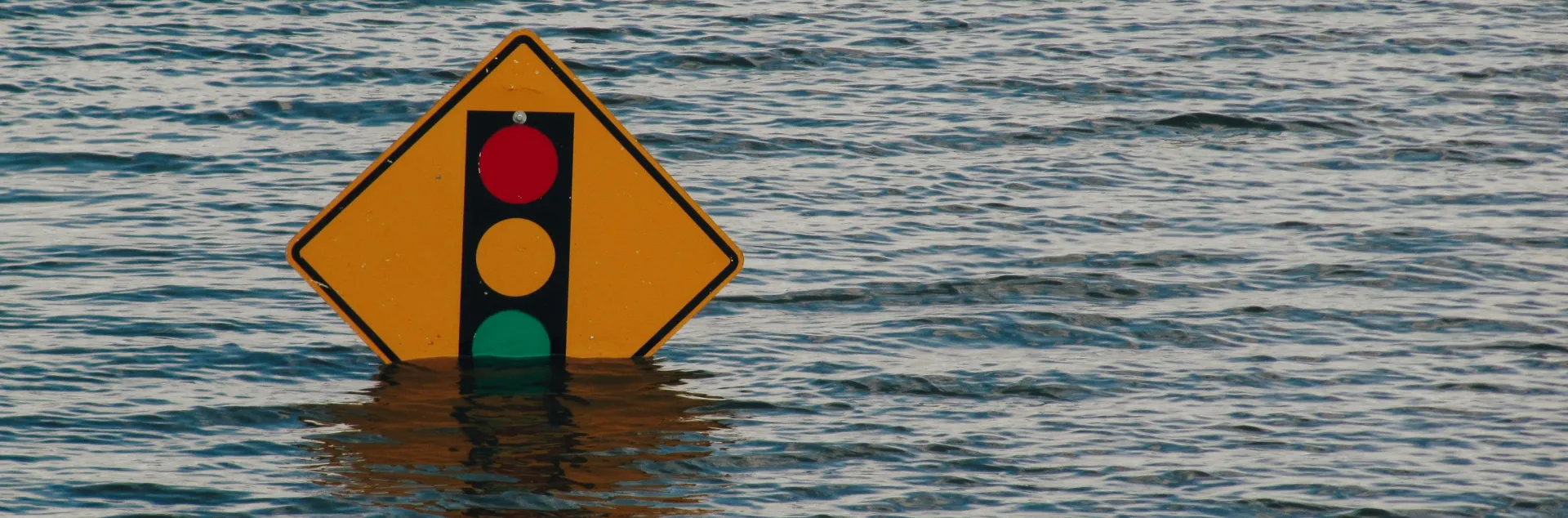 street sign halfway under water due to flood