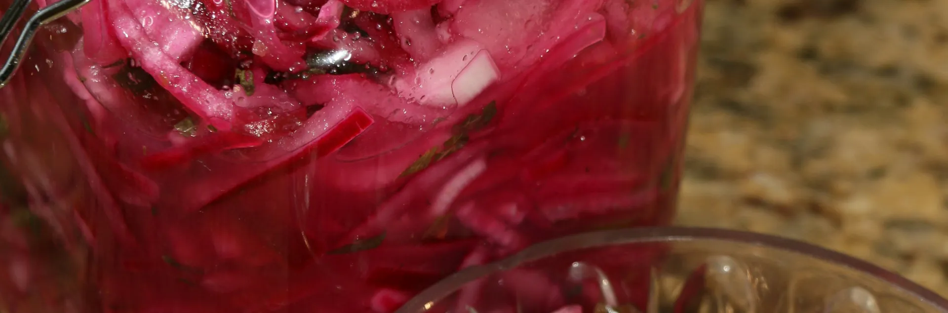 two glass jars of pickled red onions