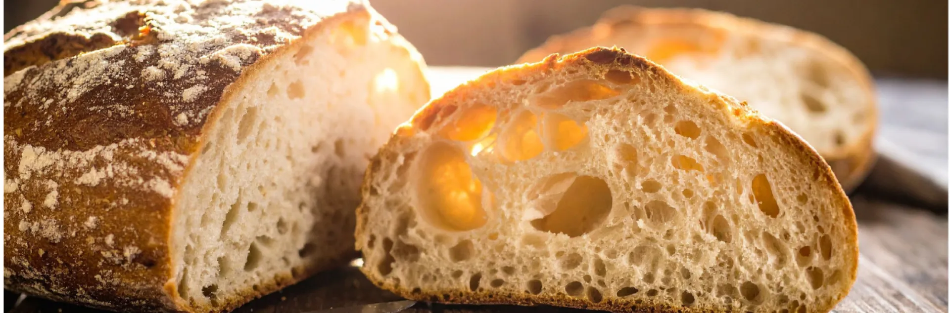 Sourdough loaf cut on half on the table.