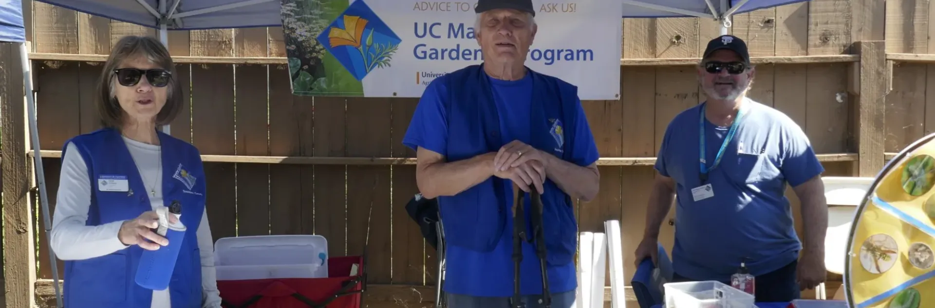 Three master gardeners at an event
