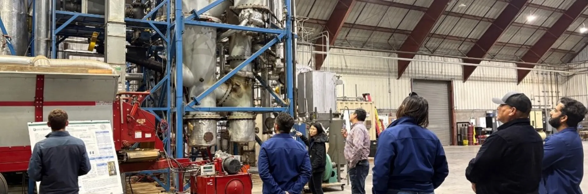 Figure 3. Dr. Li Wang, lead development scientist at the West Biofuels R&D facility, explaining the design of its gasification system