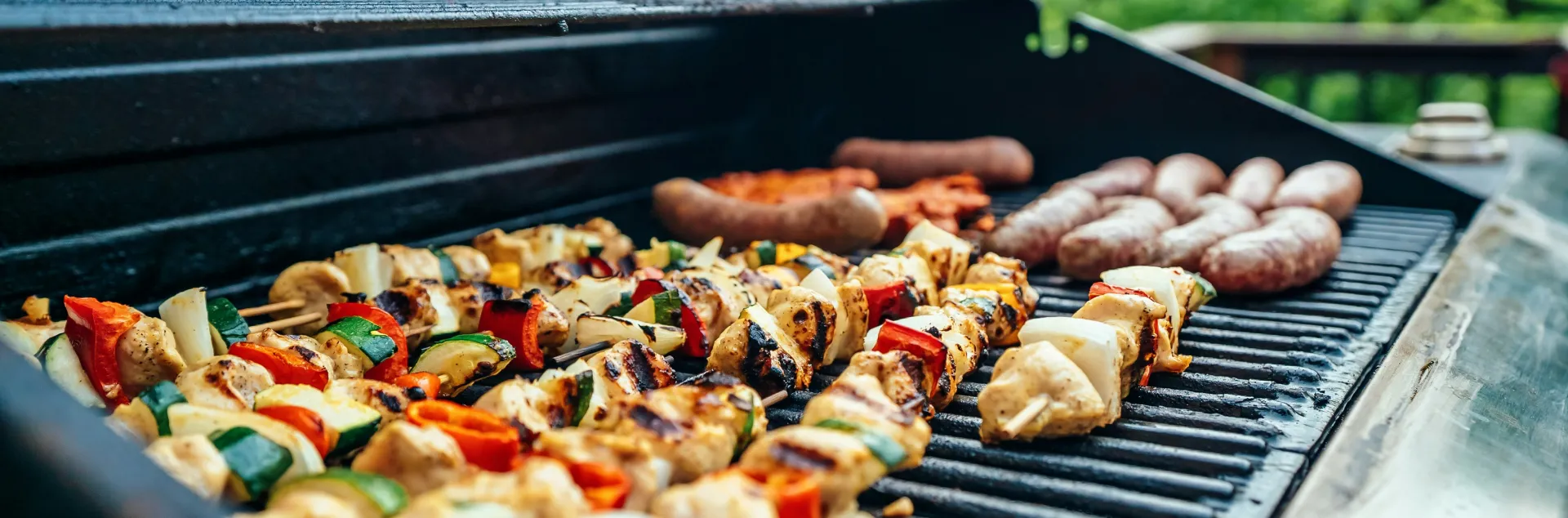 Variety of food cooking on a BBQ.