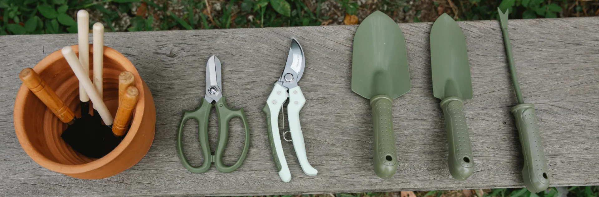 Gardening tools on wooden bench in yard By: Gary Barns from Pixels