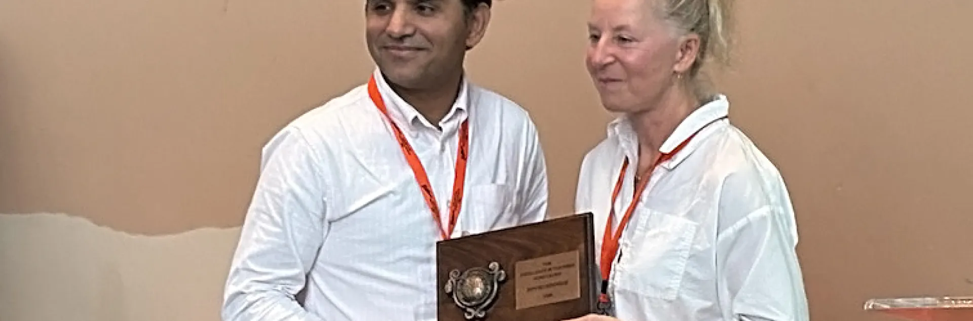UC Davis nematology professor Shahid Siddique receives the Excellence in Teaching Award, Society of Nematologists, from the Dorota Porazinska, associate professor at the University of Florida and chair of the SON Awards Committee.