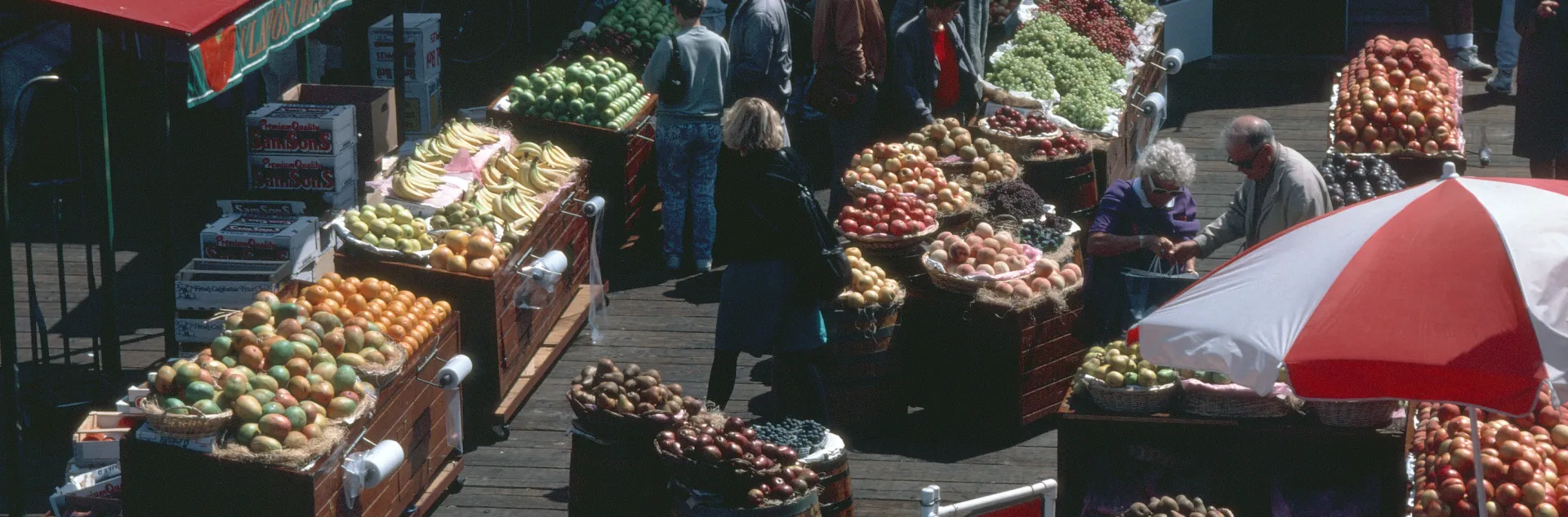 Miscellaneous photo of farmers market. Bins of produce at Pier 39 Market in sunshine. By Jack Kelly Clark, UC IPM