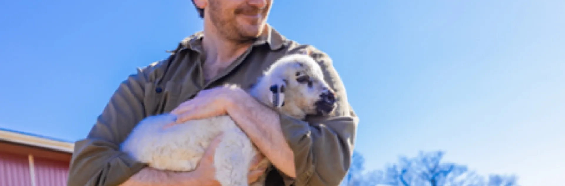 man holding a lamb in his arms