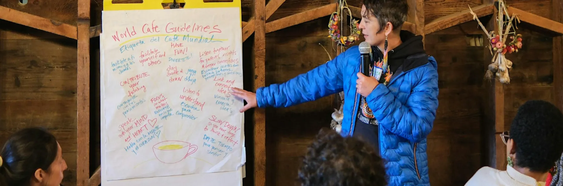 person standing at a flip chart with notes