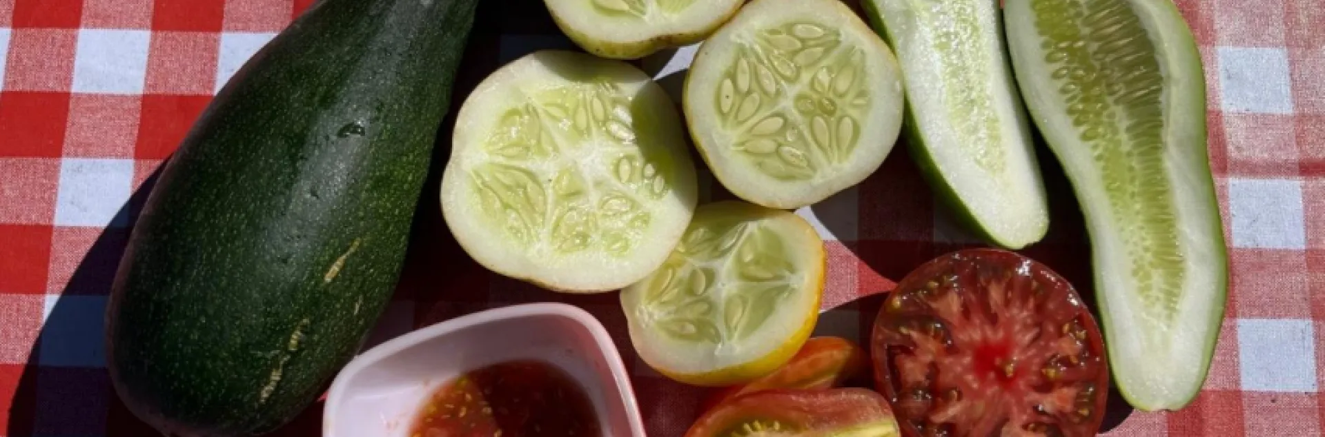 zucchini, lemon cucumbers, and tomatoes cut in half to display seeds