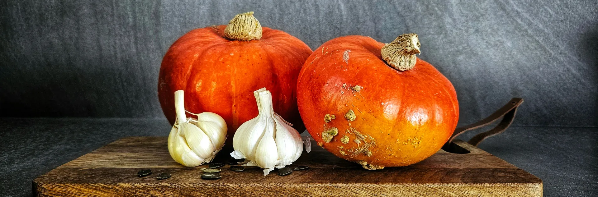 two orange round squash and two garlic cloves
