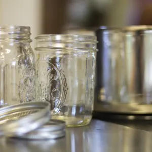 Clean jars next to canner on the stove. 