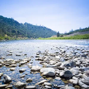 River shore with rocks and view of mountains