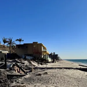 Aftermath of the Palisades fire, picturing a home on the beach that was burned by wildfire.