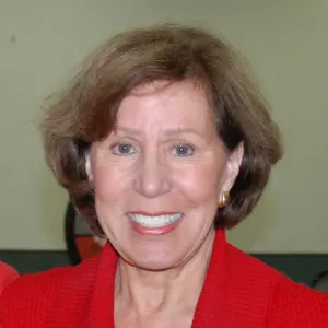 A smiling Master Gardener in a red top.