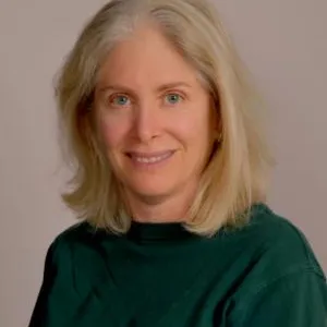 A smiling Master Gardener in a dark green shirt.