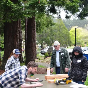 UC Berkeley Cooperative Extension Specialist Dan Sanchez assists participants with making mass timber panels.