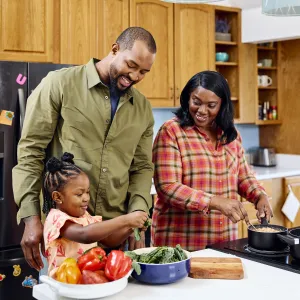 Image of a grandma, dad, and young child prepare a meal together in a home setting. Credit: USDA.