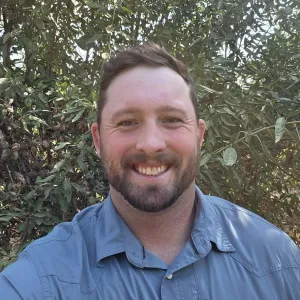 Man with short blonde hair smiling