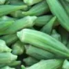 Harvested green okra pods in a bin