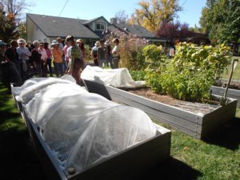 People standing by a covered raised bed