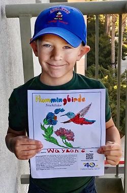 Master Gardener Sue Lovelace’s grandson, Waylon, with his coloring page.