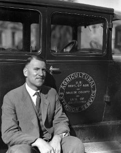 M.B. Boissevain, Marin first Farm Advisor, sitting on the running board of his Model T Ford, 1928